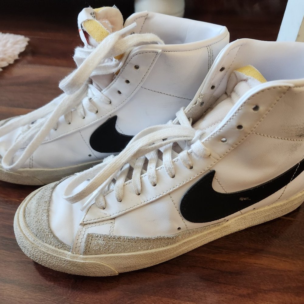 white nike high tops with black swoosh